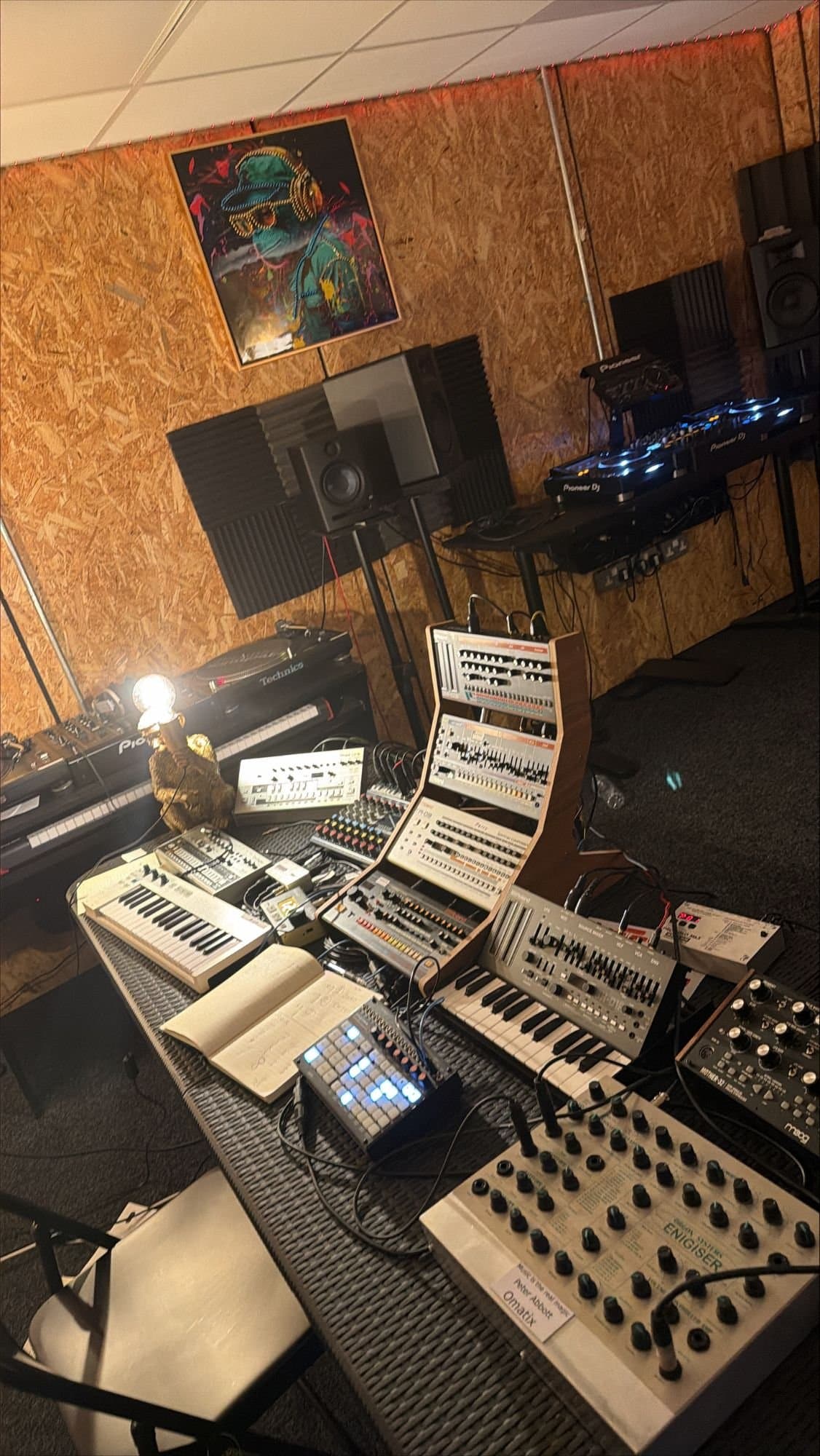 The synth corner at night, lit by the lamp on the Technics turntable